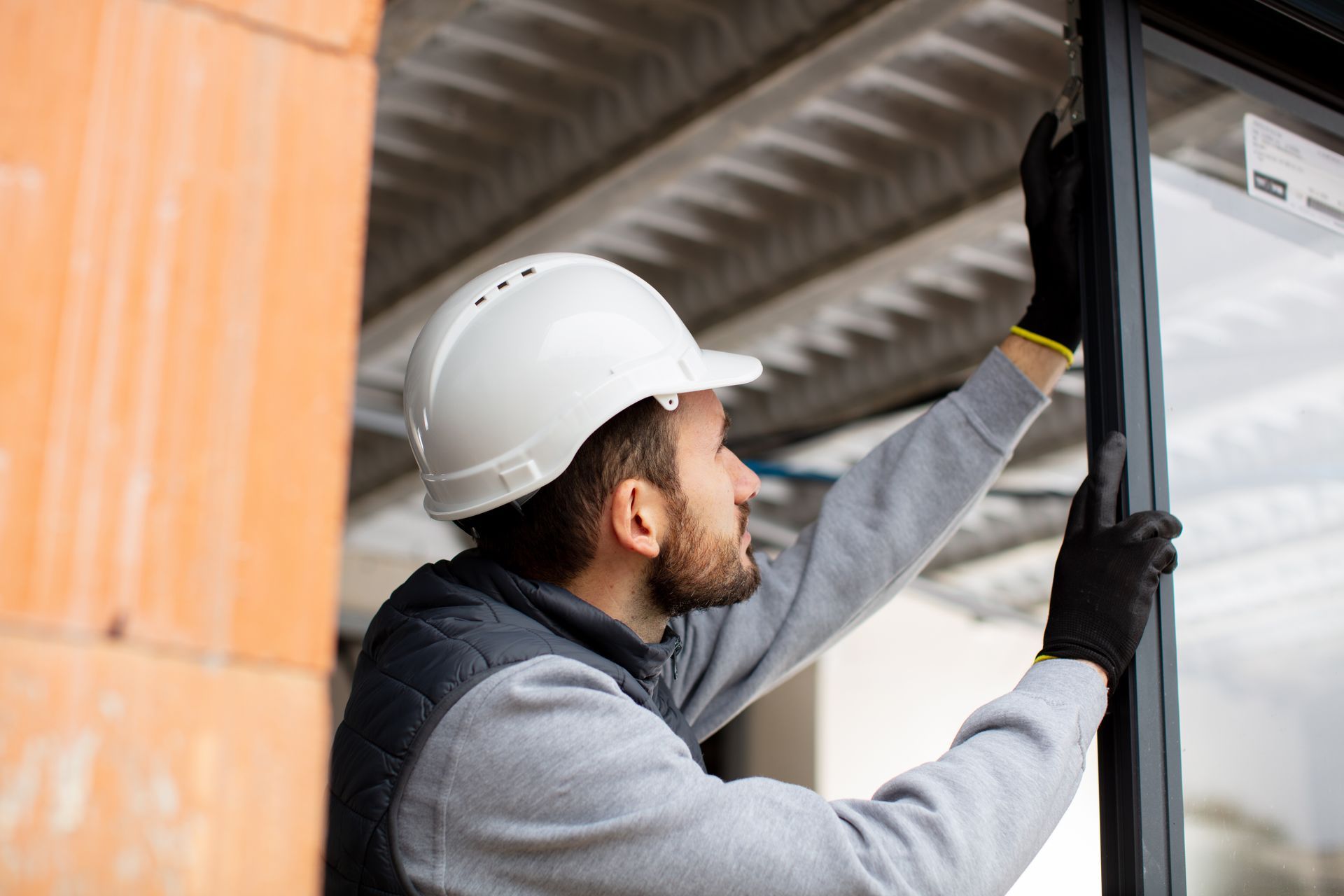 A male installer is installing a sliding door