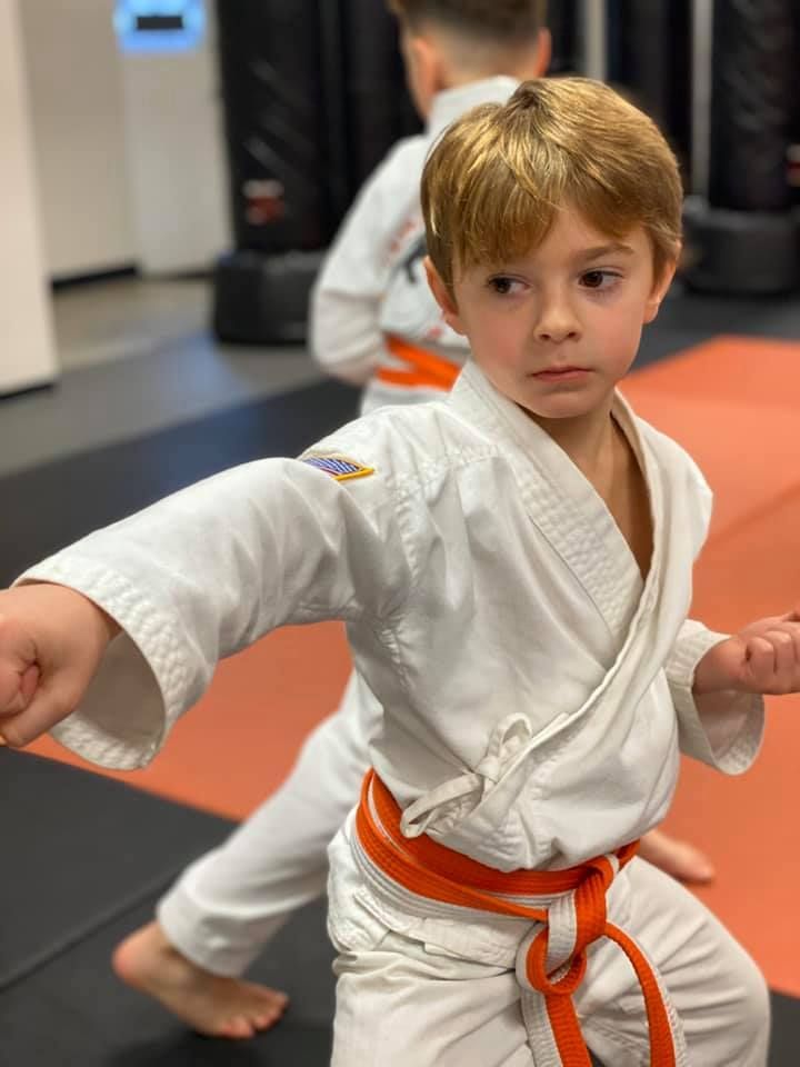 A person is holding a sparkler in their hand in the dark.