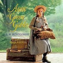 Anne of Green Gables, holding a bag, sits on a trunk. She wears a bonnet and dress, outside with trees behind her.