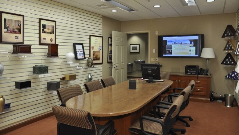 A conference room with a long table and chairs