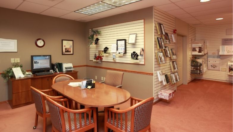 a conference room with a table and chairs and a computer on the desk