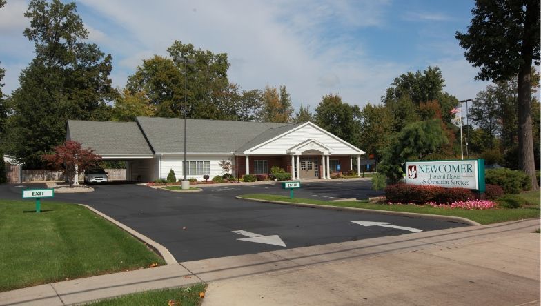 a large brick building with a parking lot in front of it