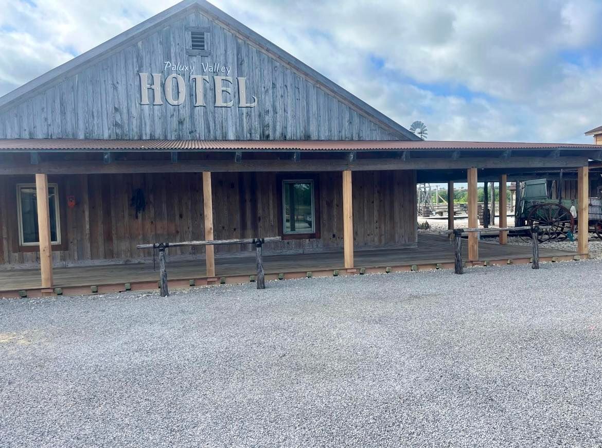 Rustic hotel with wooden siding, sign 
