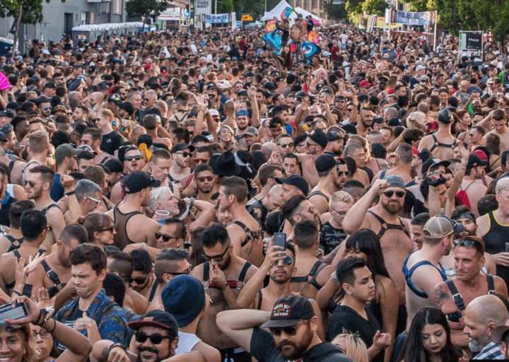 A large crowd of people are gathered in a park.