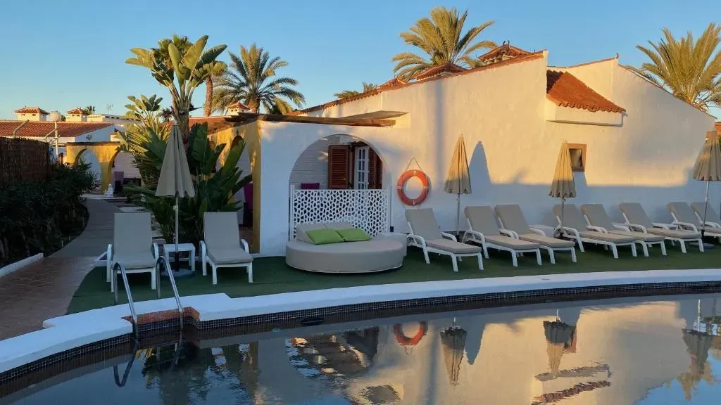 A large white building with a swimming pool in front of it