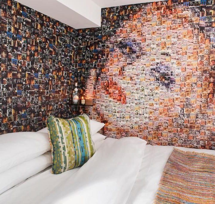 A bedroom with a painting of a woman on the wall