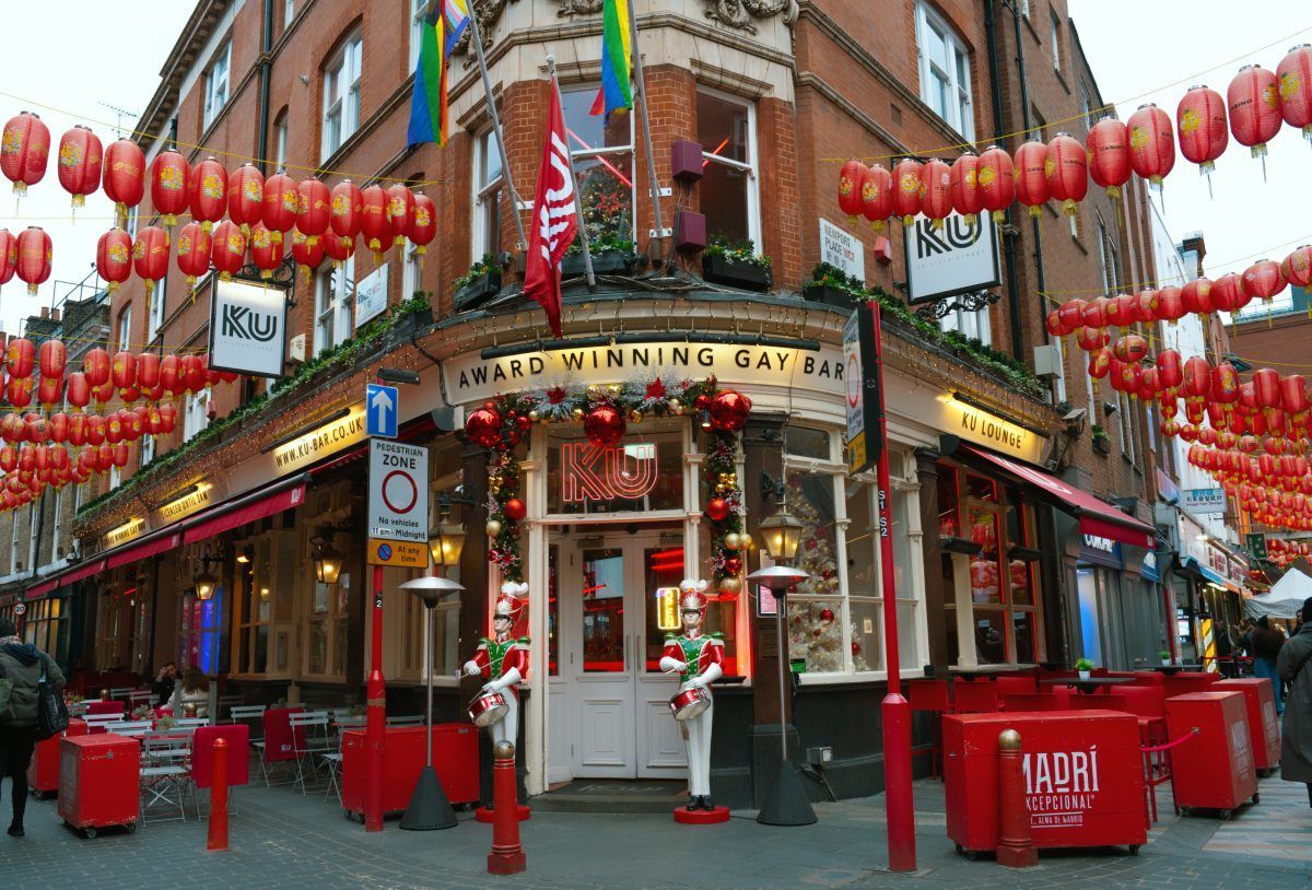 Corner building with red decorations and lanterns in Chinatown, London. KU Bar