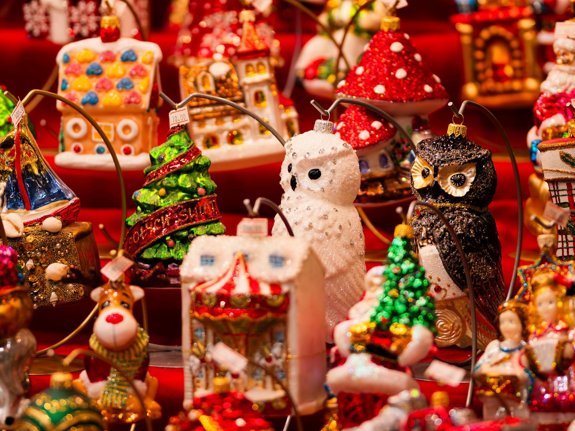 Skier wearing rainbow flag cape on a snowy mountain, skis down slope with poles.