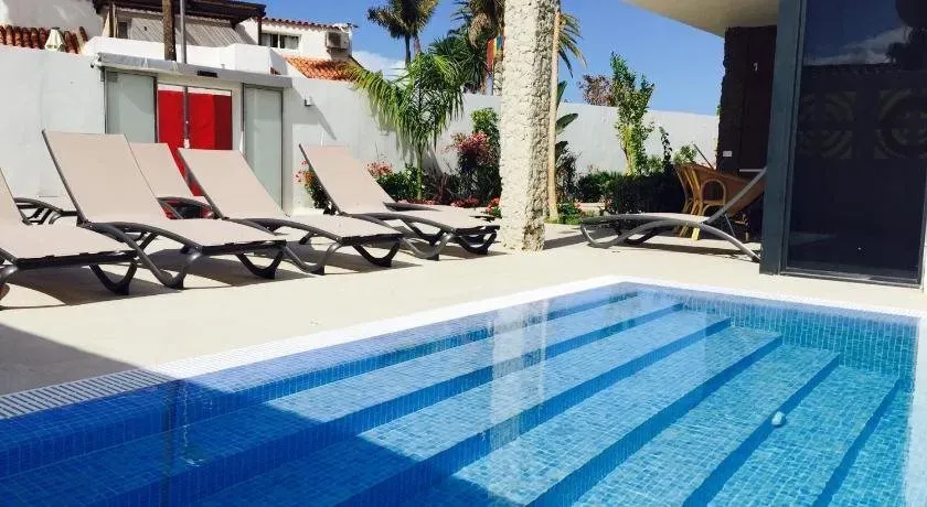 A swimming pool with a lot of chairs around it