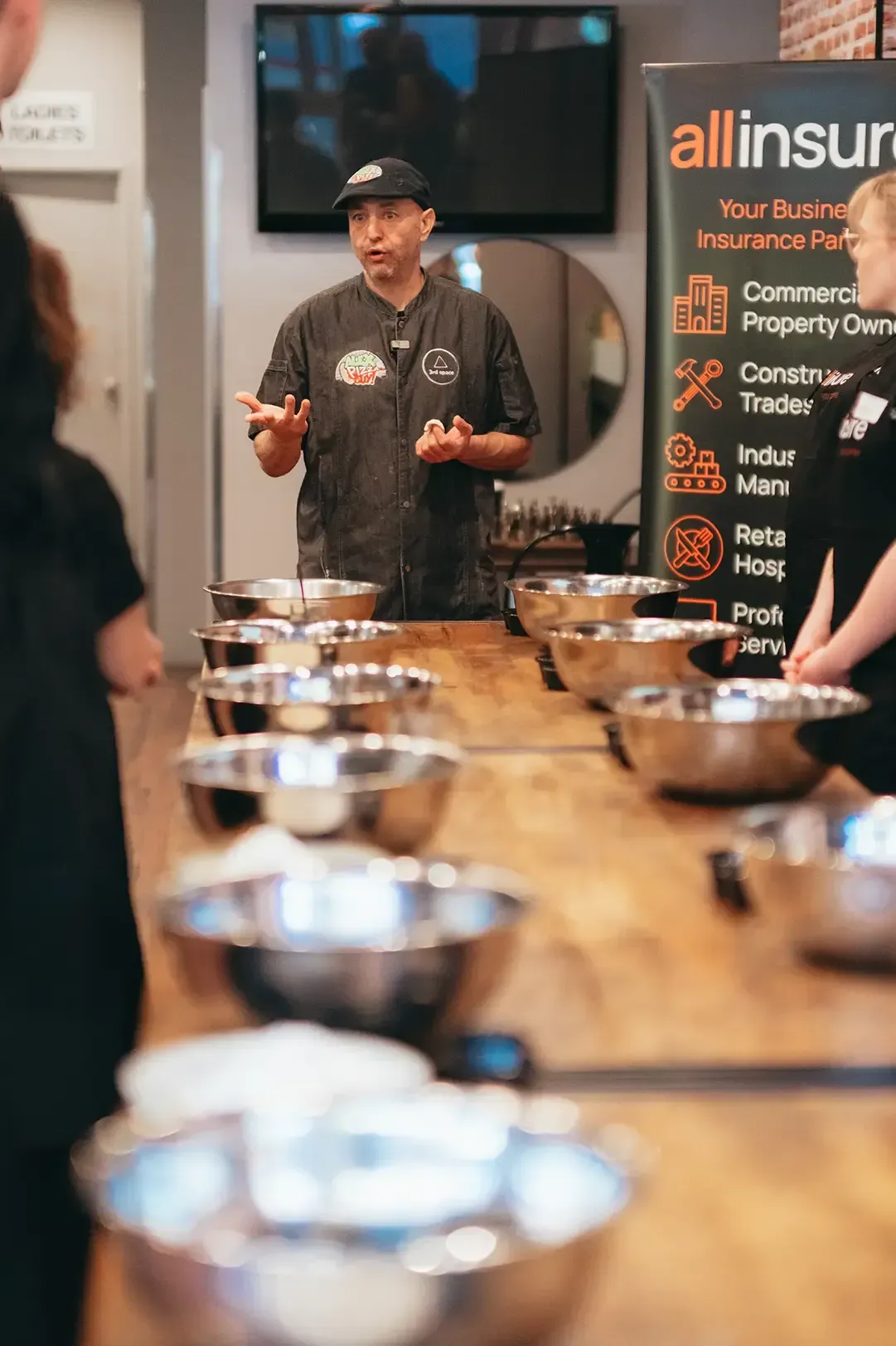 A man is standing in front of a mirror talking to a group of people.