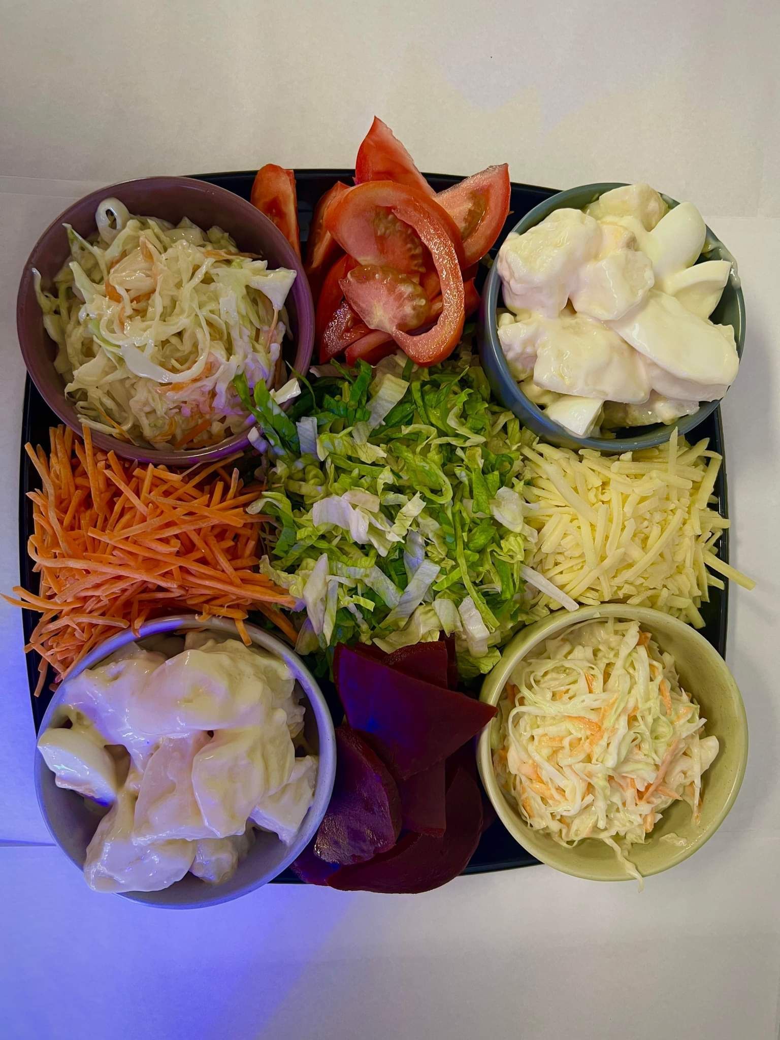 Tray of assorted salad ingredients: shredded cabbage, carrots, cheese, tomatoes, beets, and eggs. — Boundary Street Fish & Burger Bar in Railway Estate, QLD