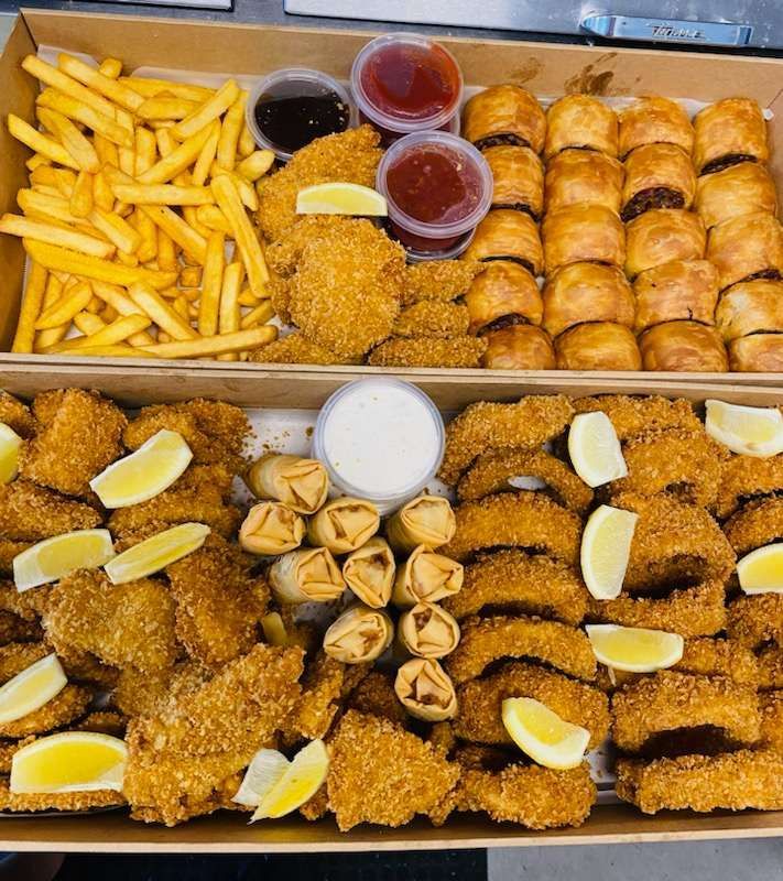 Takeout platters with fries, chicken, sausage rolls, spring rolls, and dipping sauces. — Boundary Street Fish & Burger Bar in Railway Estate, QLD