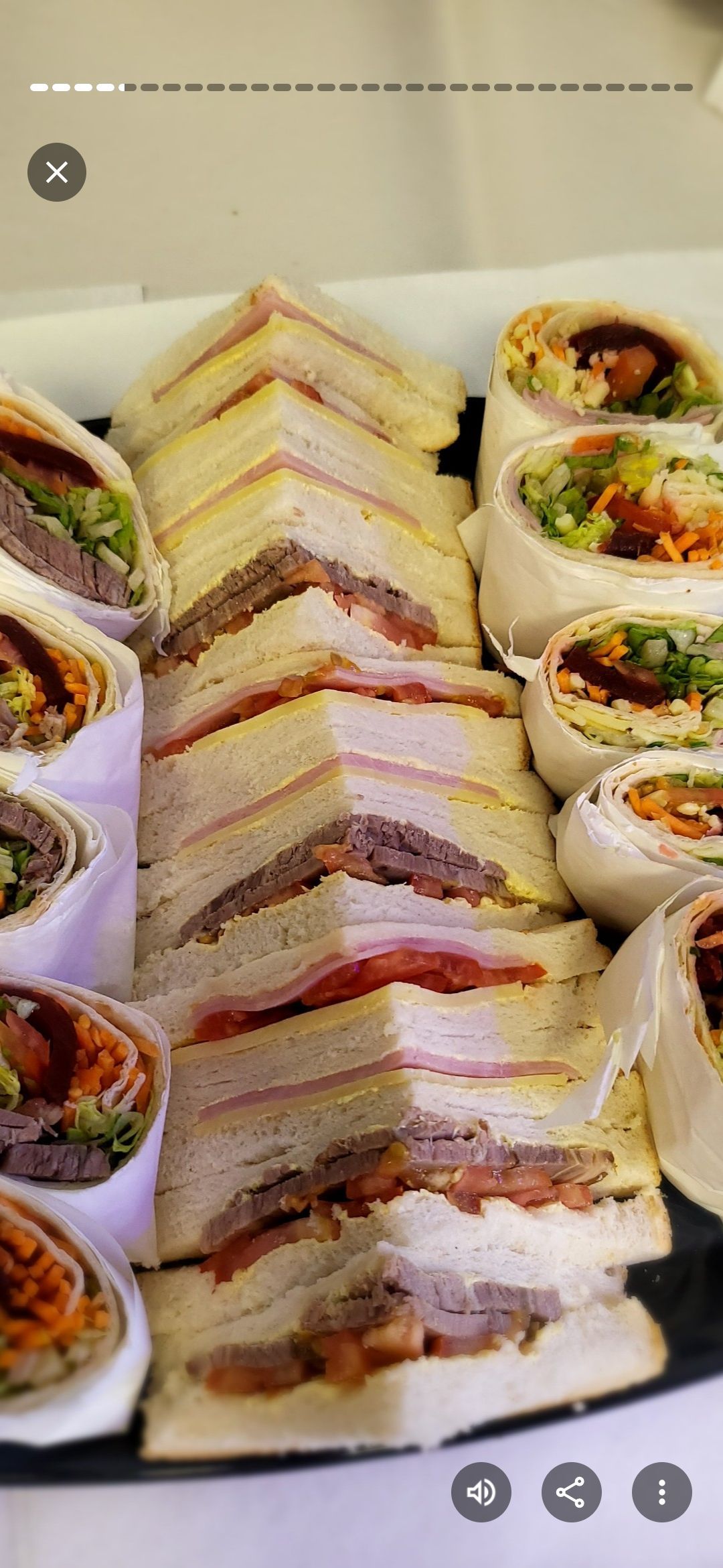 Sandwiches and wraps on a black tray. Triangle-cut sandwiches stacked alongside rolled wraps. — Boundary Street Fish & Burger Bar in Railway Estate, QLD