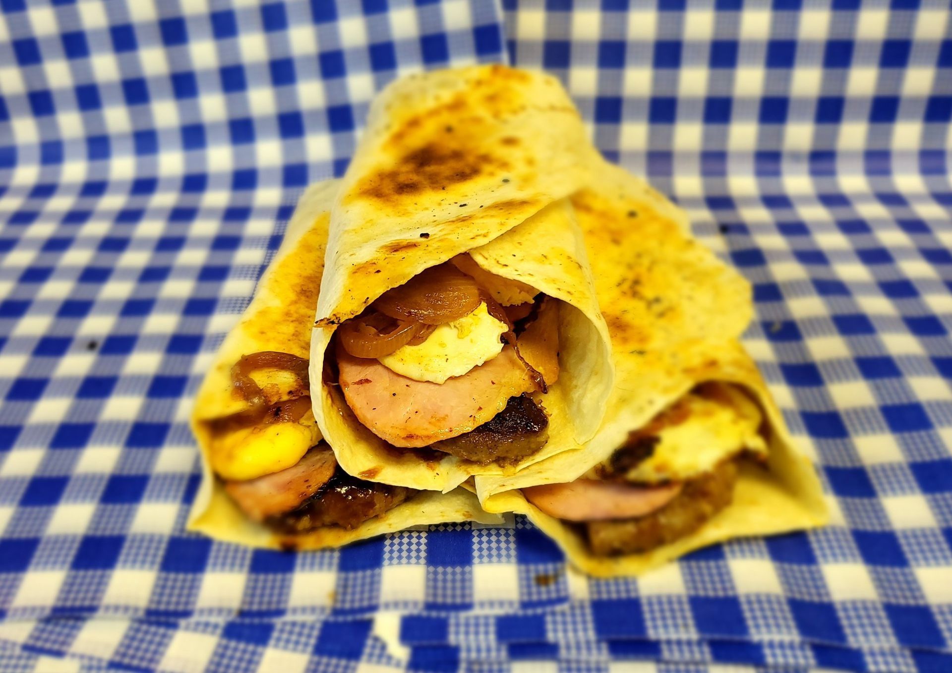 Wrap With Sausage and Cheese, on Blue and White Checkered Cloth — Boundary Street Fish & Burger Bar in Railway Estate, QLD