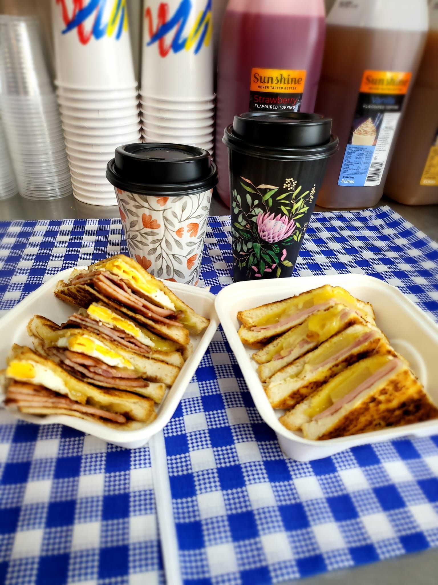 Two Sandwiches, Coffee Cups, and Drinks — Boundary Street Fish & Burger Bar in Railway Estate, QLD