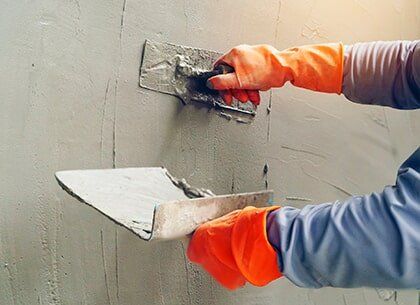 Worker Placing Concrete plaster — Home Services Foundation Repair in Fordyce, AR
