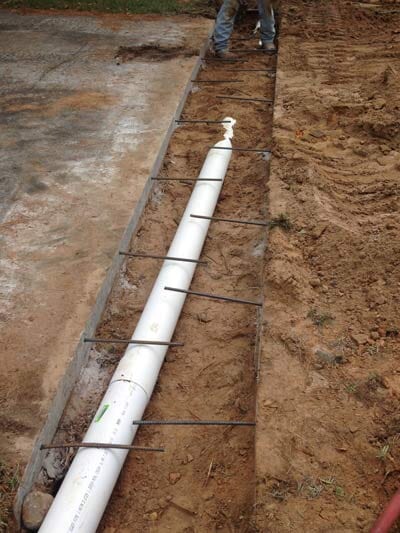 Installing Drain — Home Services Foundation Repair in Fordyce, AR Installing Drain — Home Services Foundation Repair in Fordyce, AR