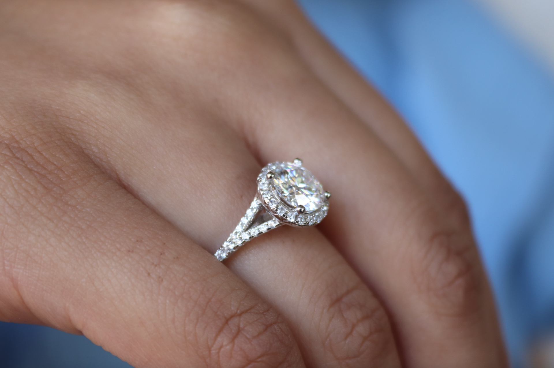 A woman is wearing a diamond ring on her left hand