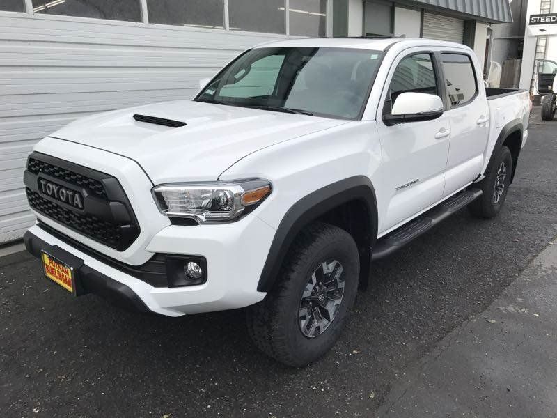 Person polishes car headlight with a power buffer.
