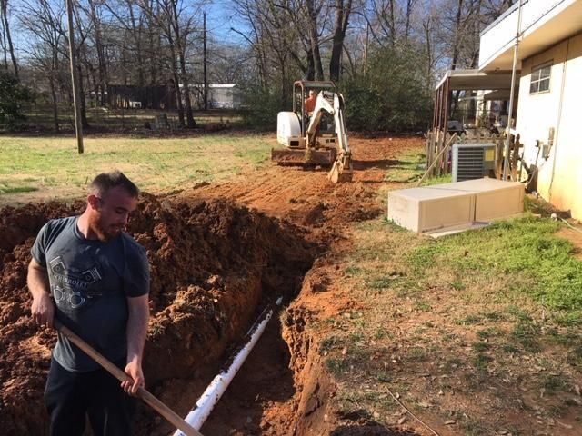 Southeastern Plumbing Plumbers working on garbage disposal pipes.