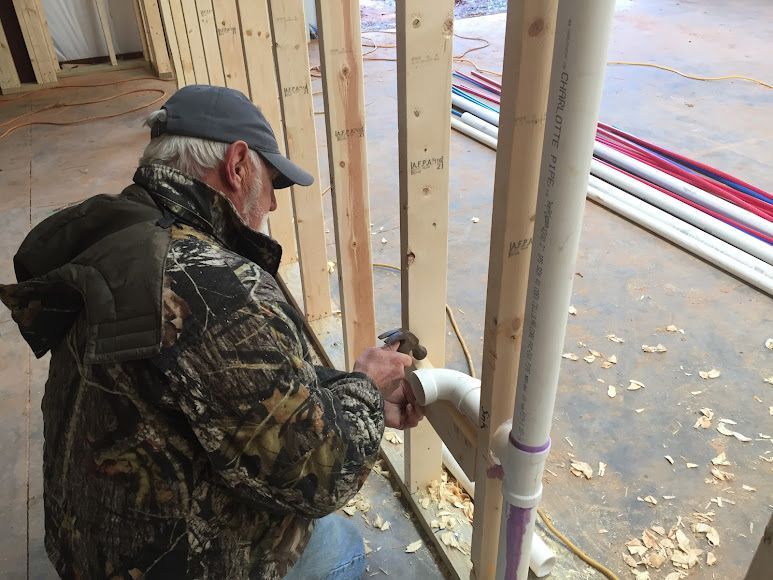 Southeastern Plumbing Plumber working on pipe in new home.