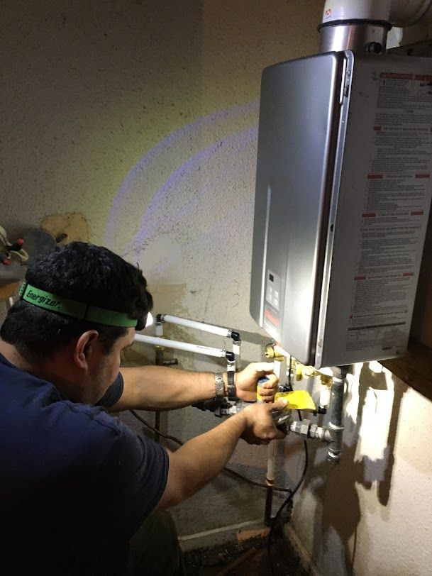 Southeastern Plumbing plumber working on water heater.