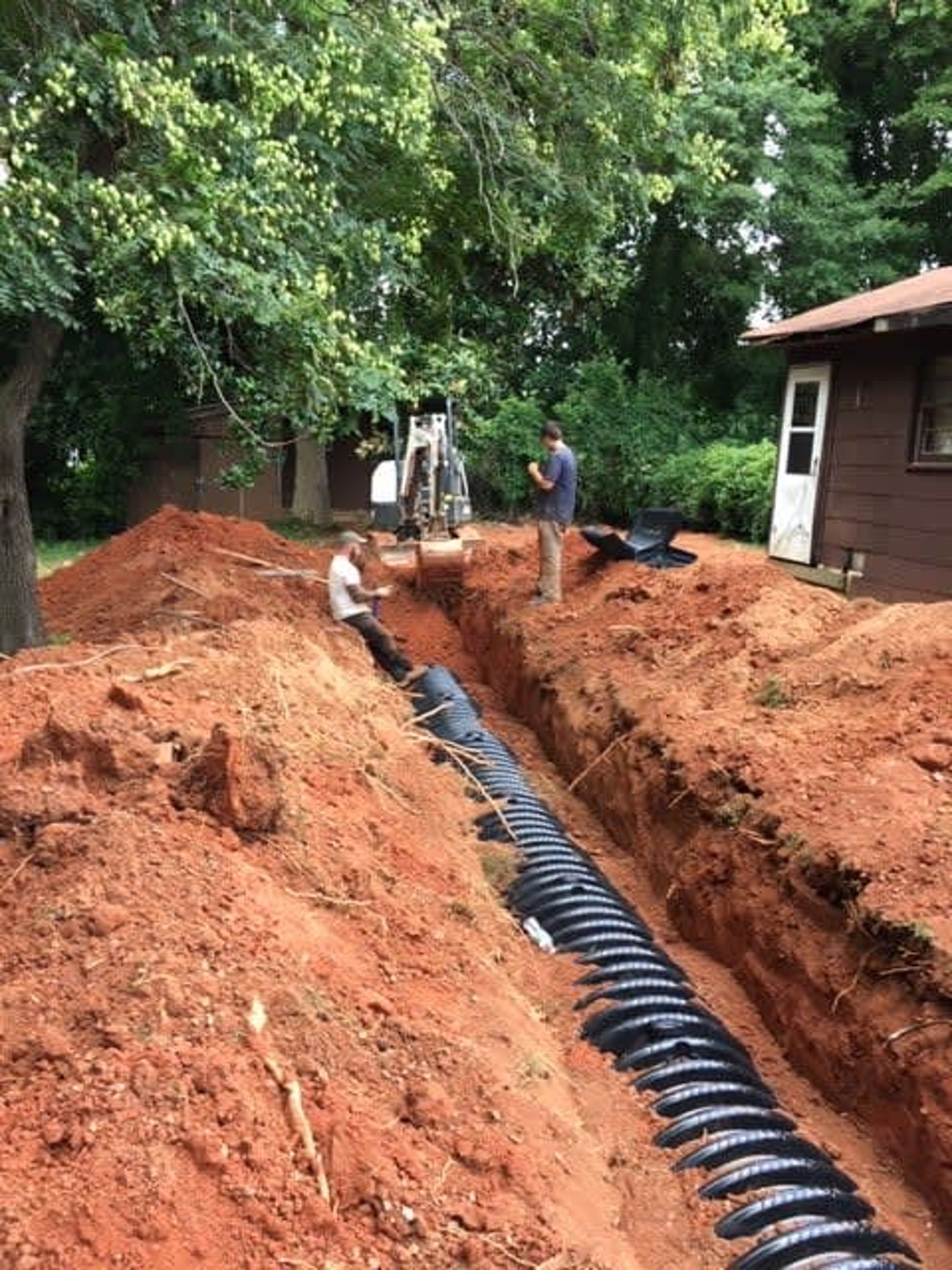 Southeastern Plumbing plumbers working on sewer or drainage system of home.