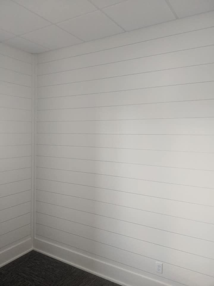 A room with white walls and a black floor.
