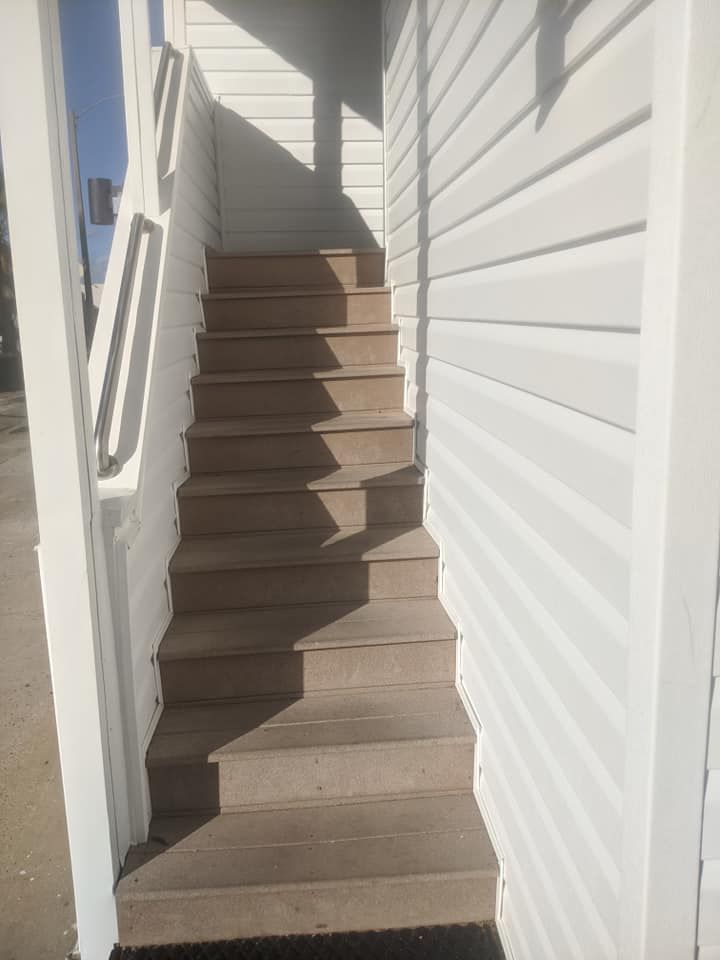 A set of stairs leading up to a white building.
