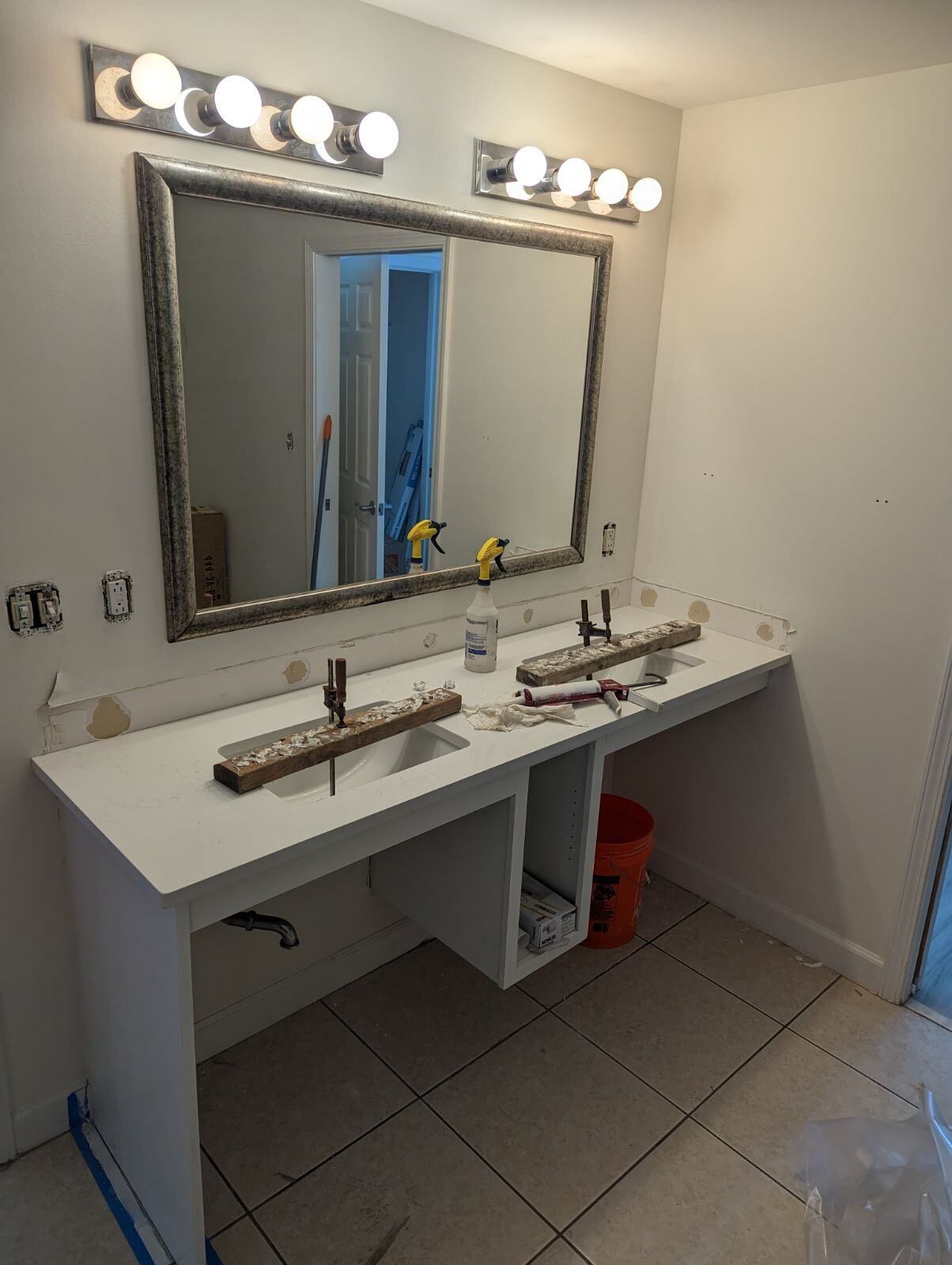 A bathroom with two sinks and a large mirror