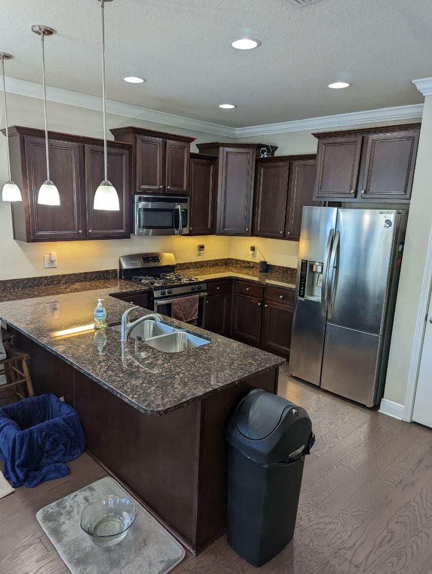 A kitchen with stainless steel appliances and granite counter tops.