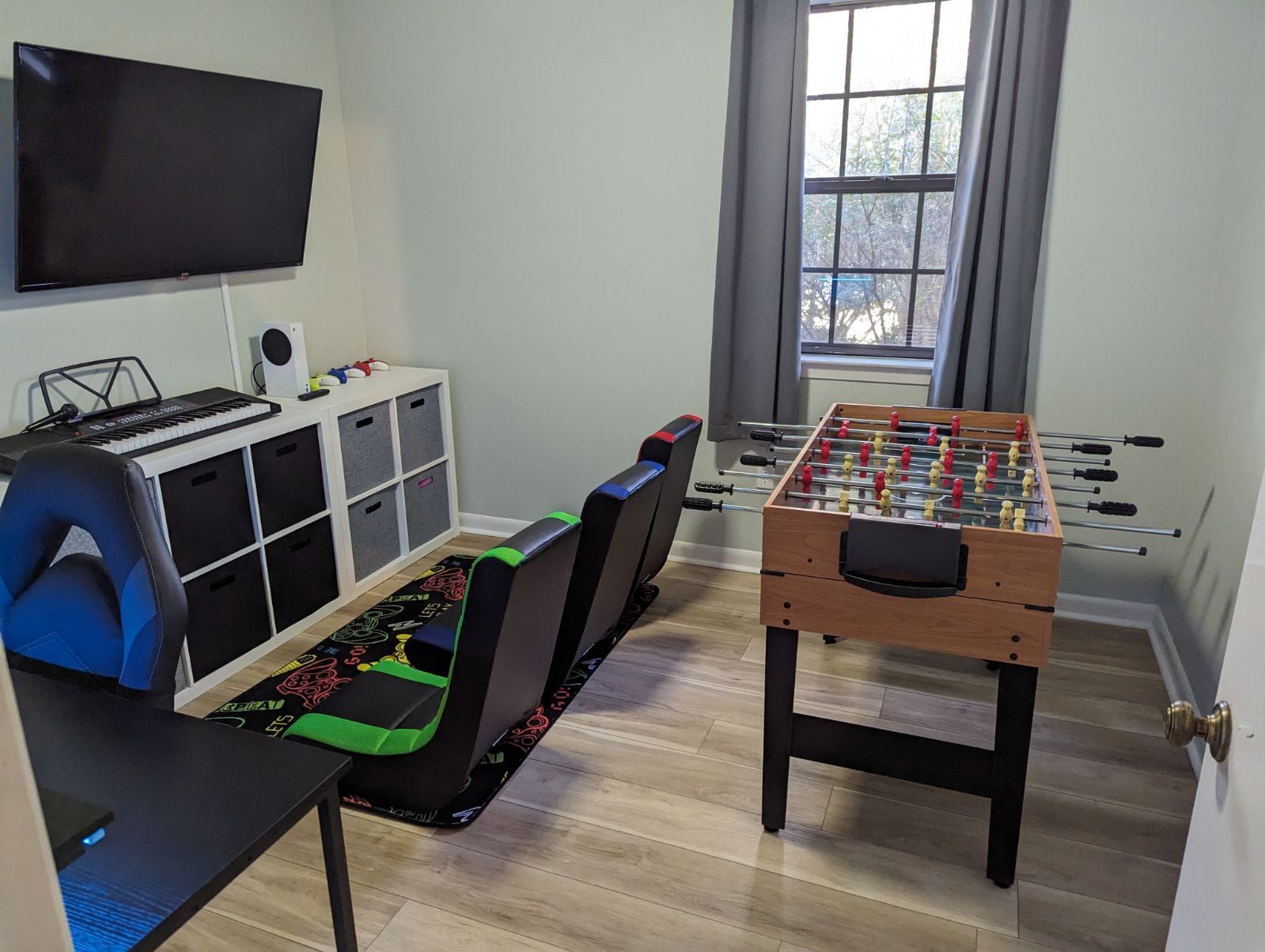 There is a foosball table in the middle of the room.