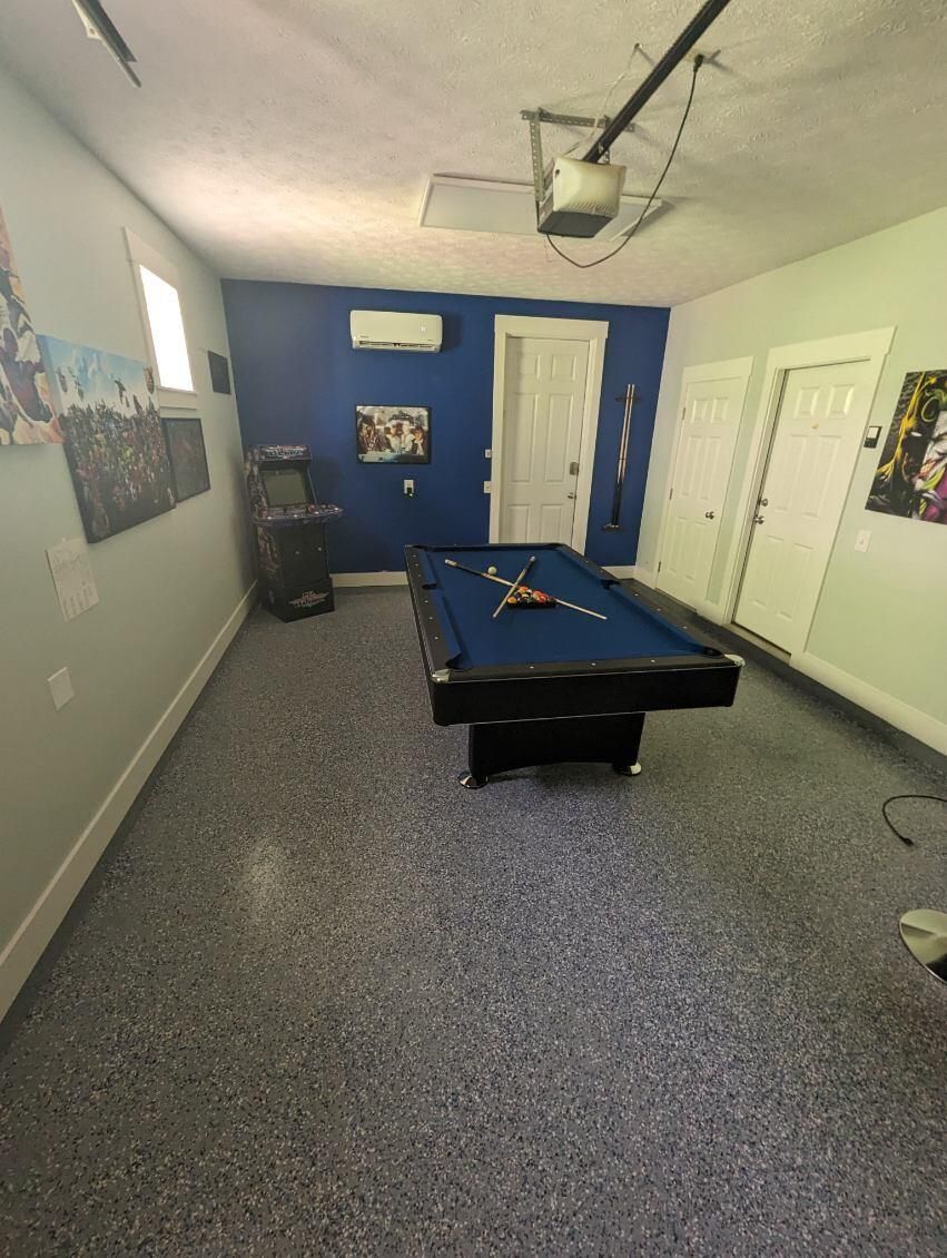 A pool table in a room with a blue wall