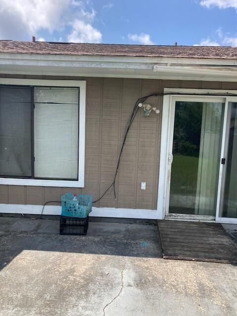 A house with a sliding glass door and a window