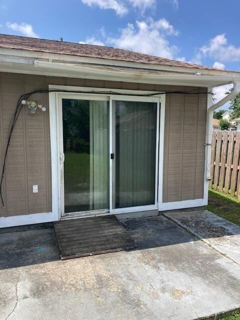 A house with a sliding glass door and a wooden fence