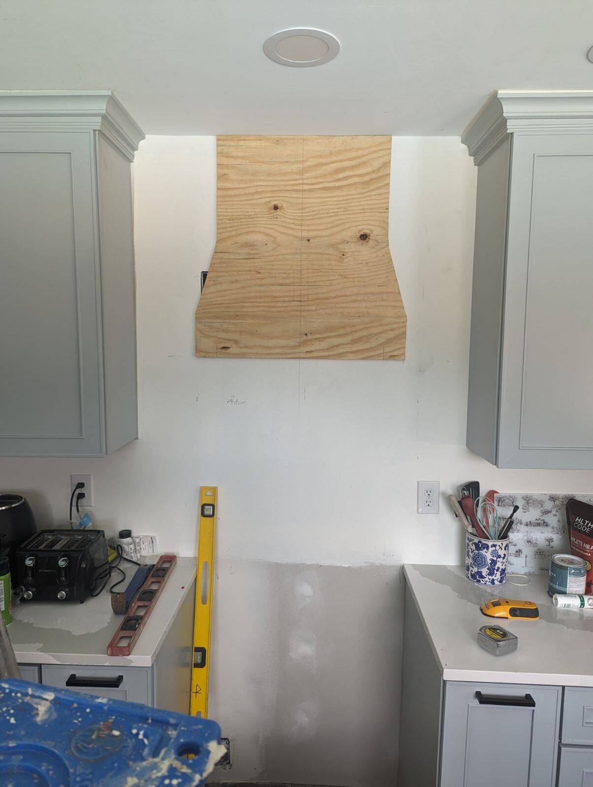 A kitchen with a wooden hood and a yellow level