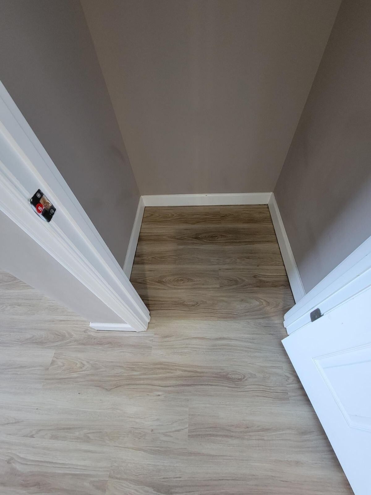 A room with a wooden floor and a white door