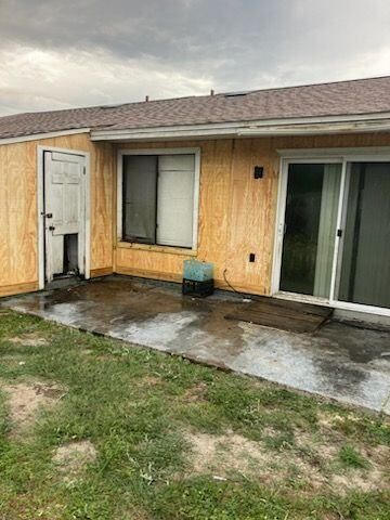A house with a sliding glass door and a dog door.