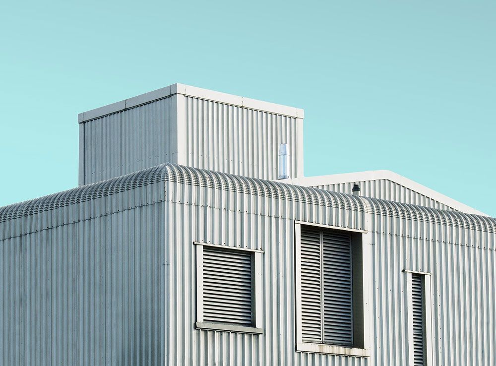 A white building with a blue sky in the background.