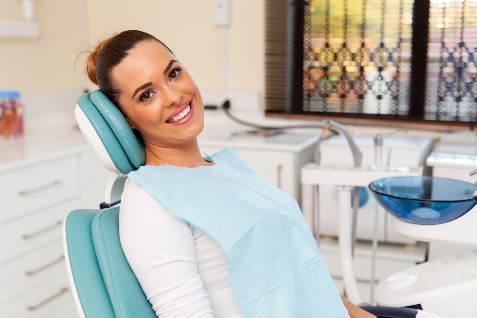 A happy patient at a dental clinic, smiling after receiving cosmetic dentistry care services.