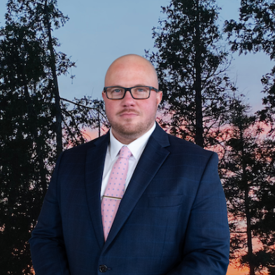 A man in a suit and tie is smiling for the camera.