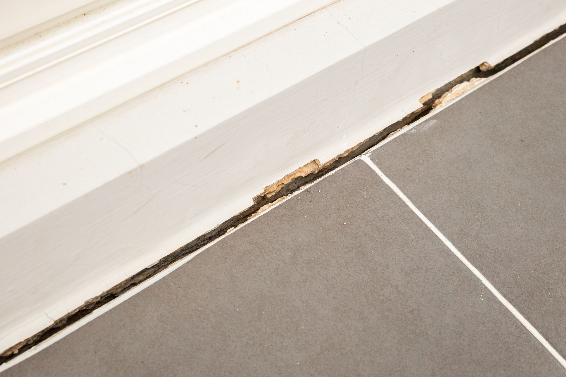 Close-up of a house floor crack caused by unstable home foundations.