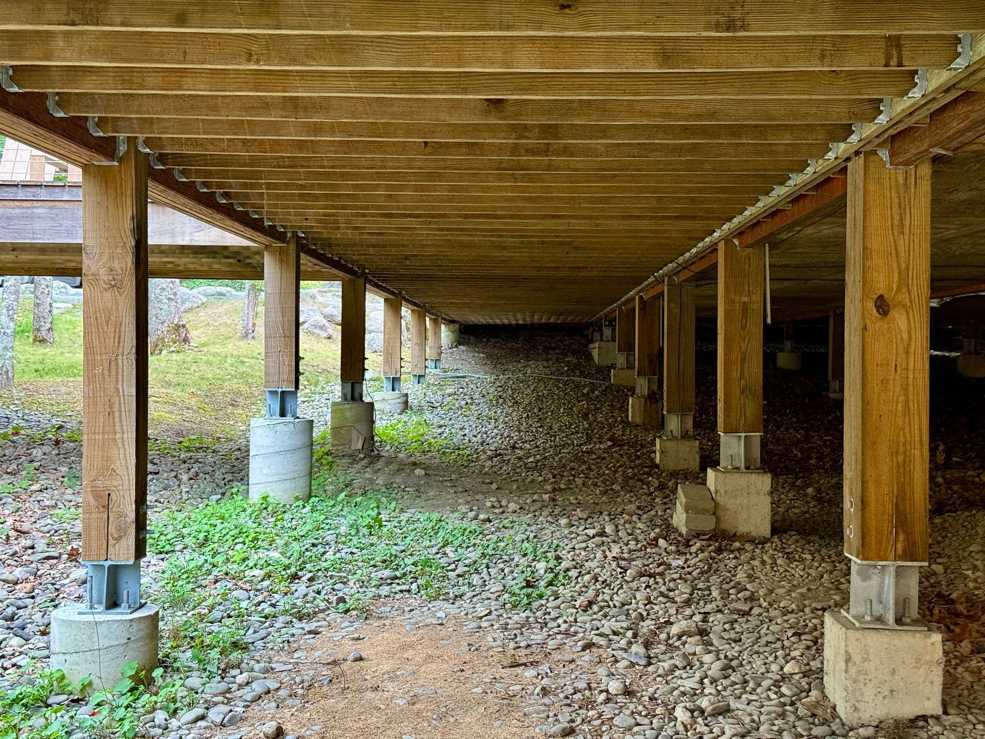 Under-deck view showing stumps and beams used in restumping process.