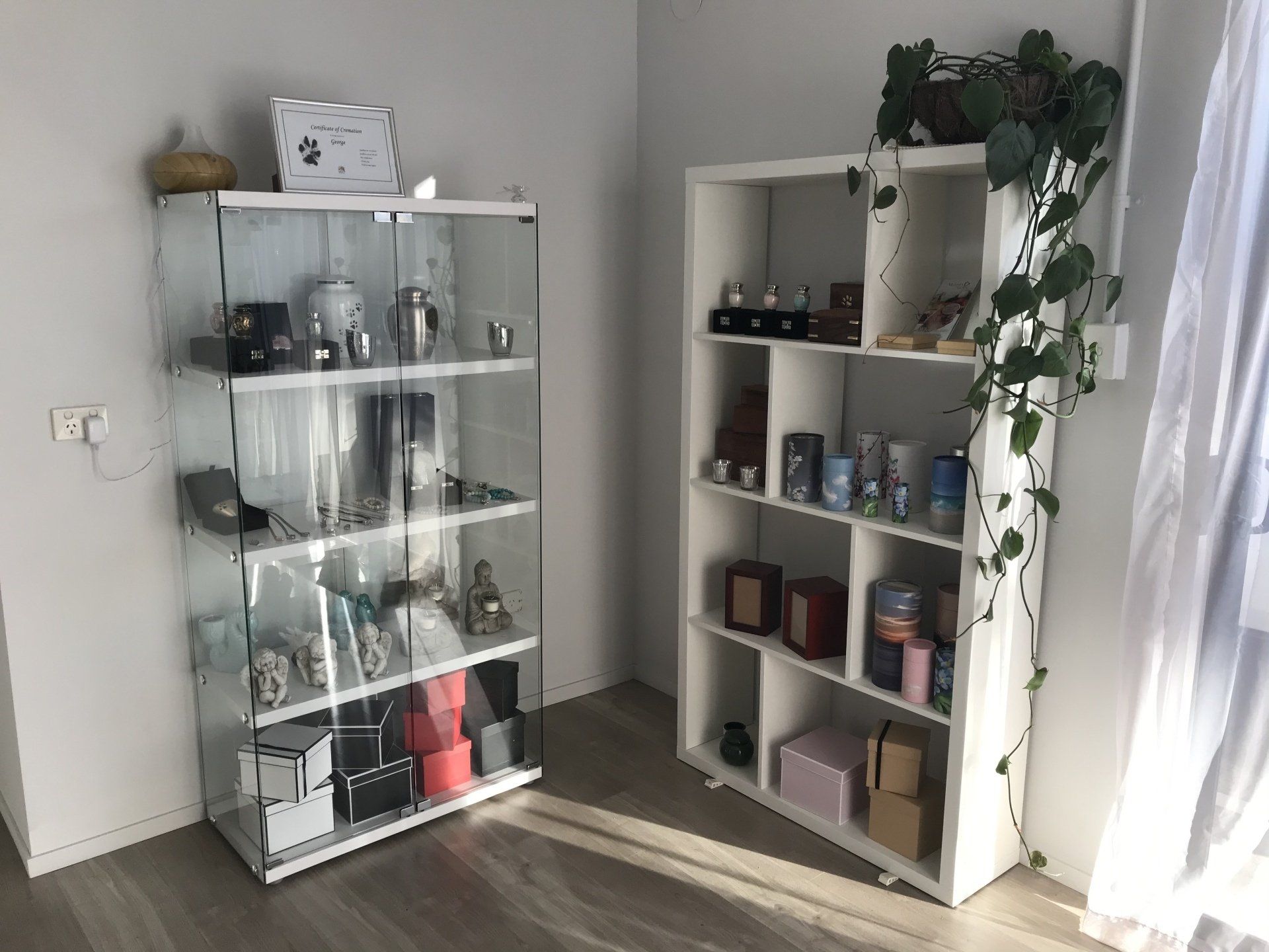 display shelves in farewell room with urns and photographs