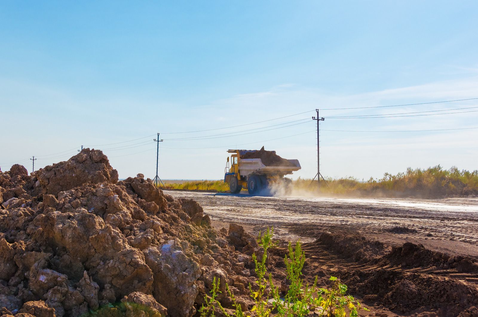 A man is riding a lawn mower on a lush green lawn.