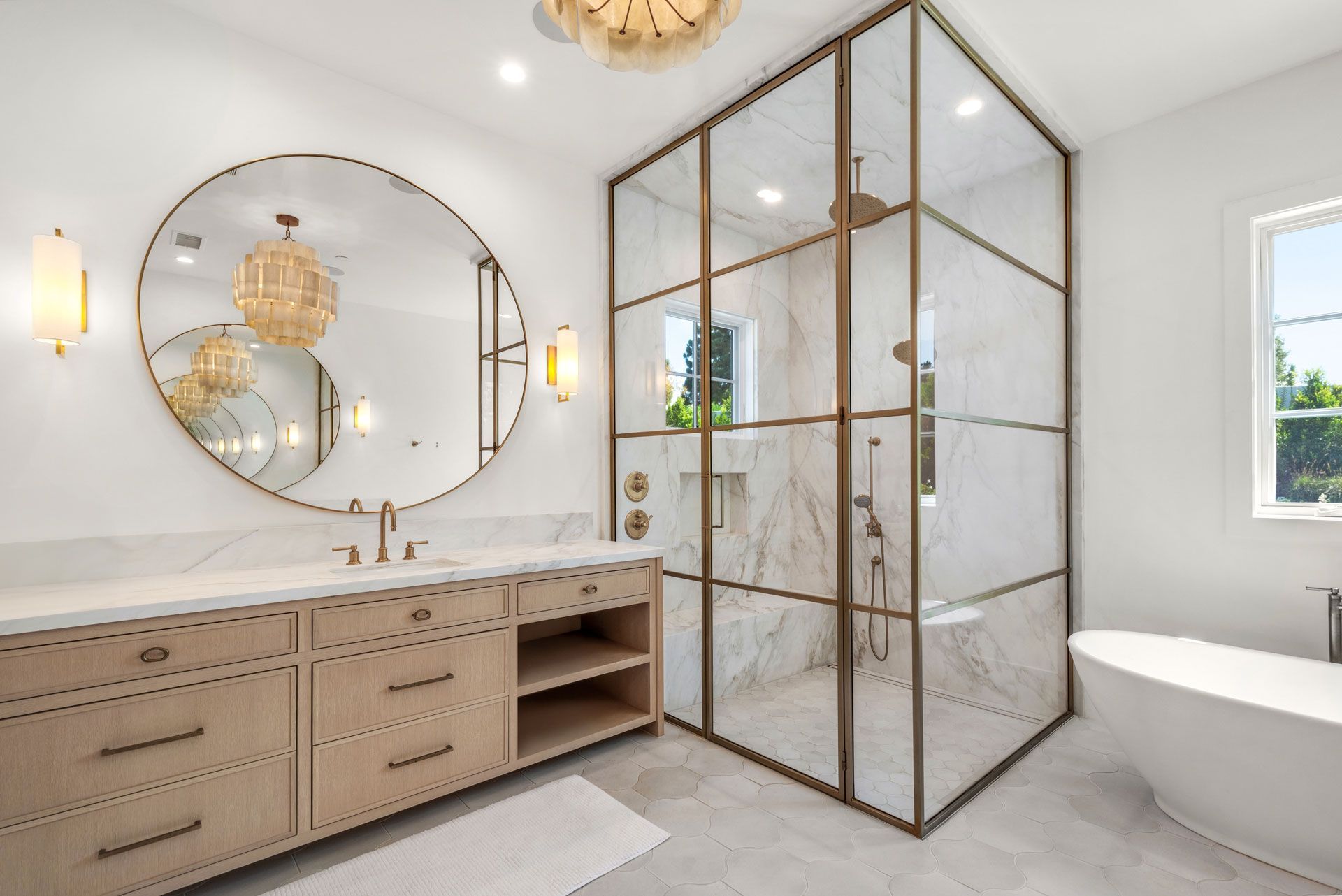 Luxurious modern bathroom with a glass shower, soaking tub, and gold accents.