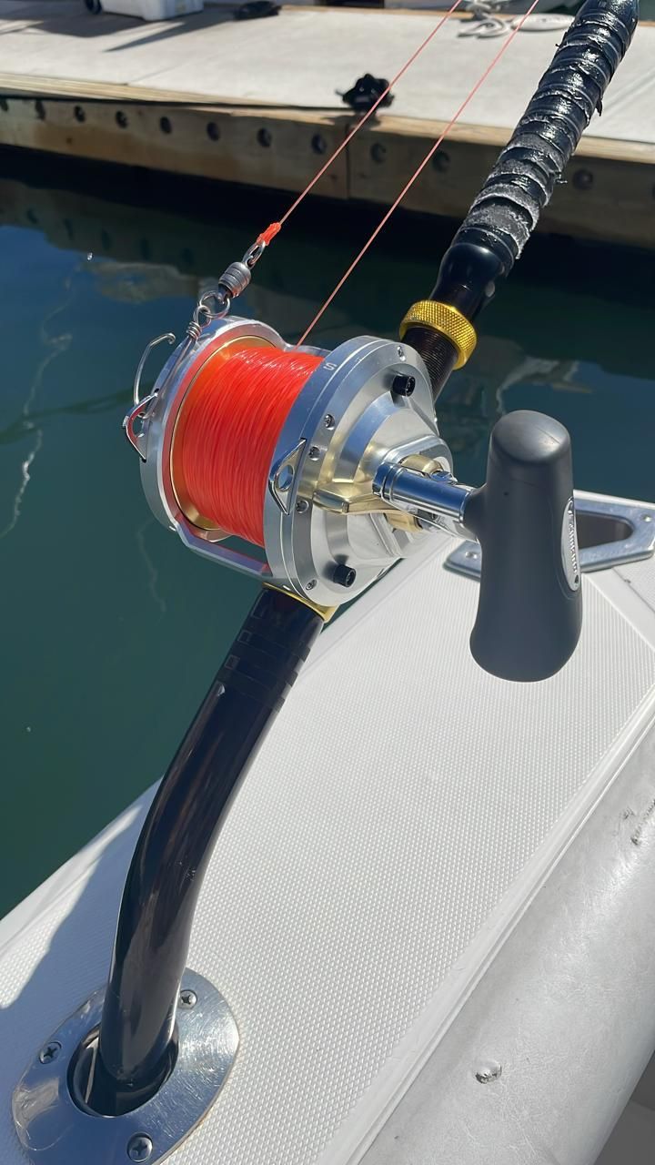 a fishing rod is attached to the side of a boat .