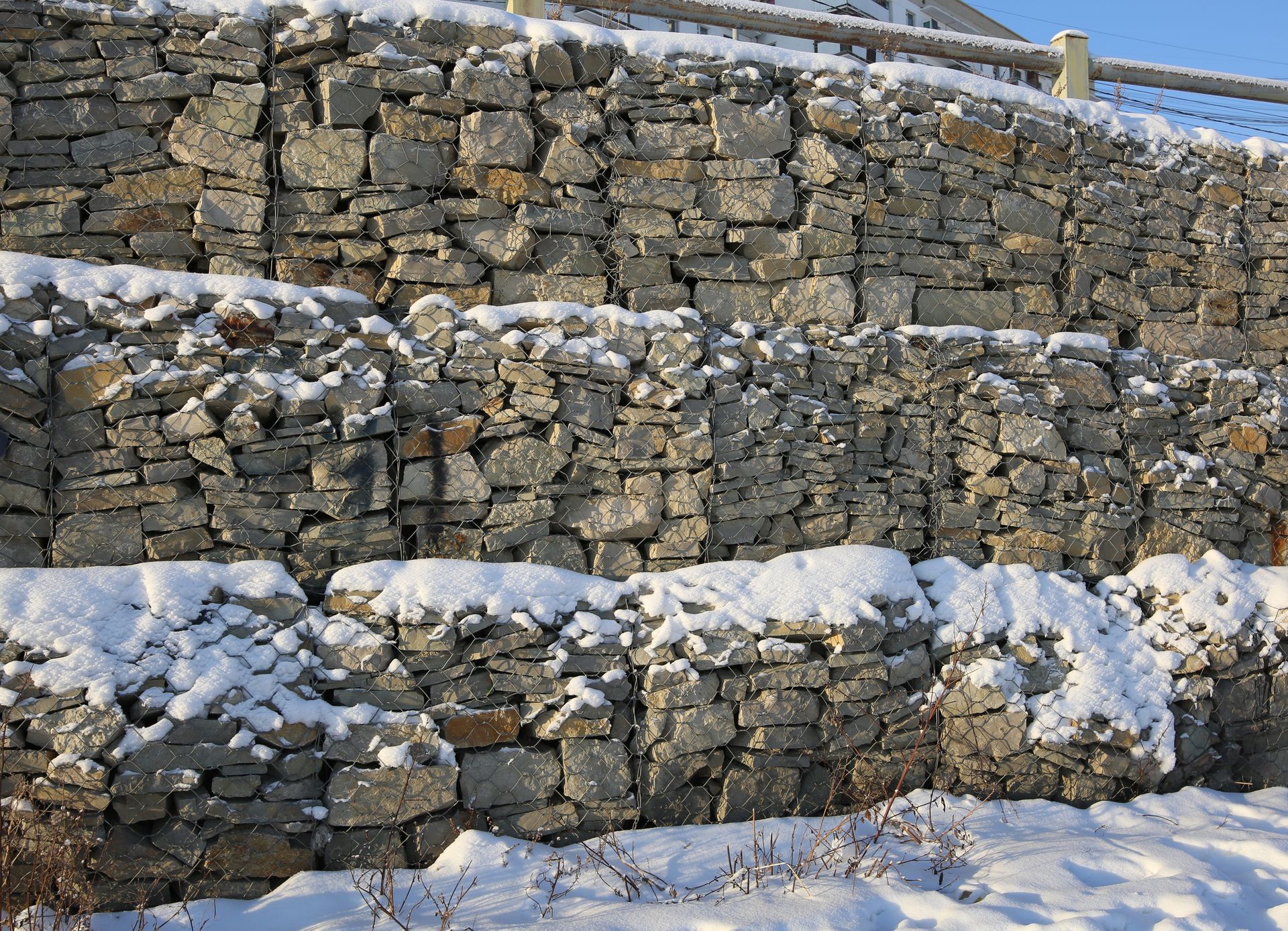 hardscaped rock wall with snow