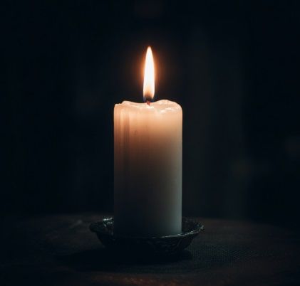 Lit memorial candle creates peaceful atmosphere for personalized remembrance in Punta Gorda, FL.