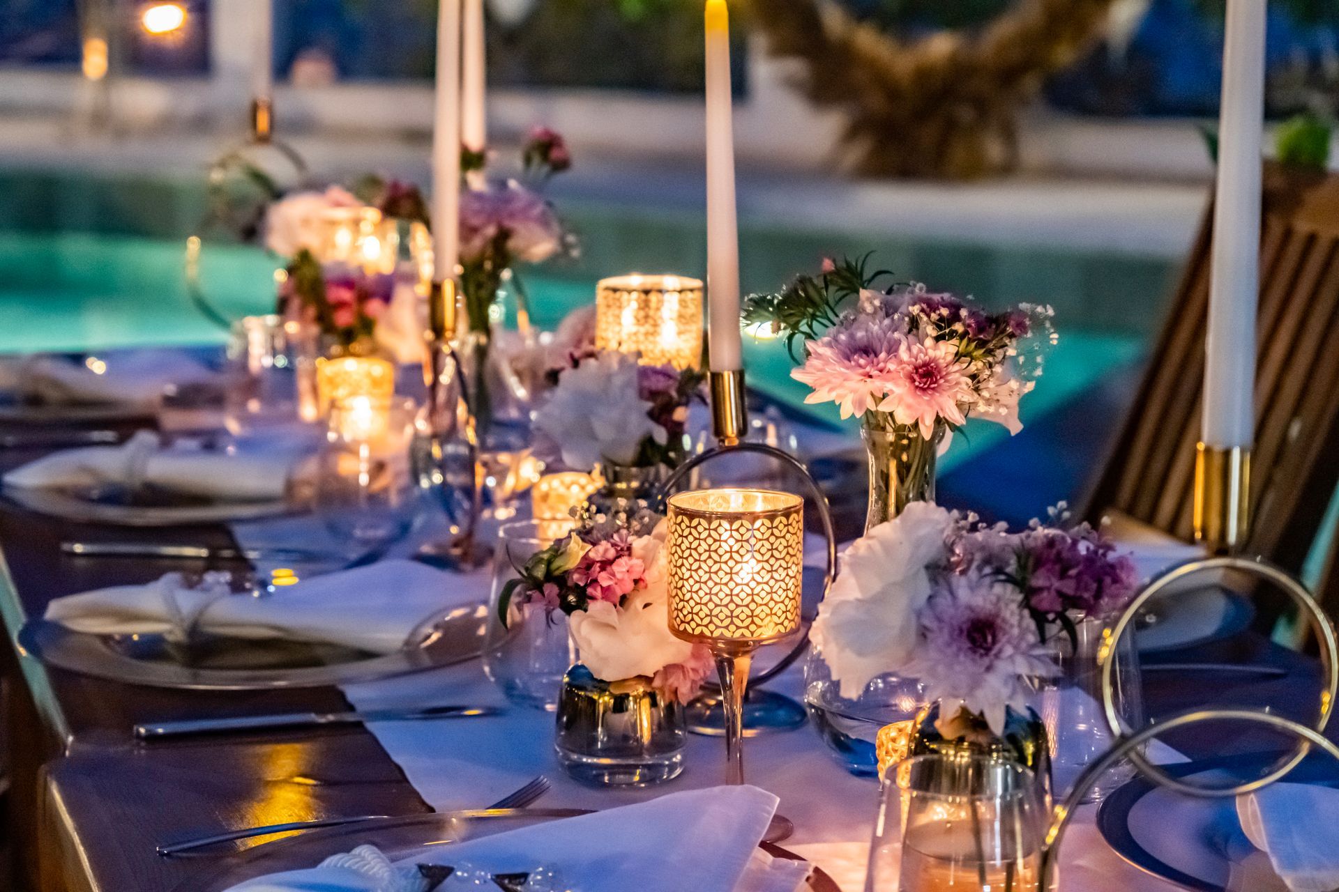 A long table with candles and flowers on it